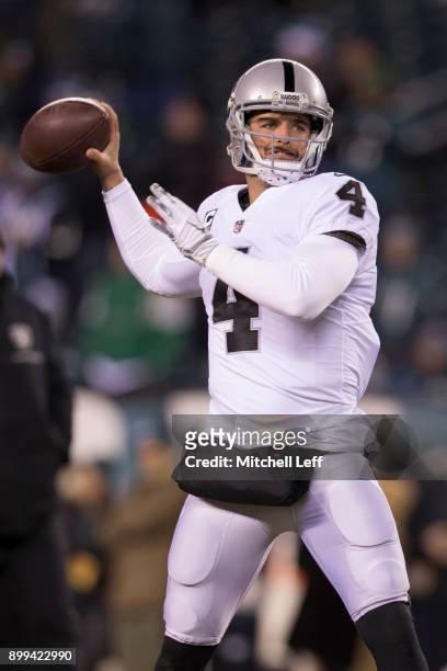Derek Carr of the Oakland Raiders warms up prior to the game against the Philadelphia Eagles at Lincoln Financial Field on December 25, 2017 in...