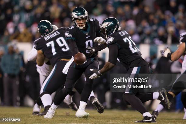Nick Foles of the Philadelphia Eagles hands the ball of to LeGarrette Blount as Brandon Brooks blocks against the Oakland Raiders at Lincoln...