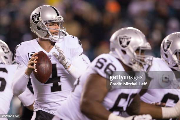 Derek Carr of the Oakland Raiders looks to pass the ball as Gabe Jackson blocks against the Philadelphia Eagles at Lincoln Financial Field on...