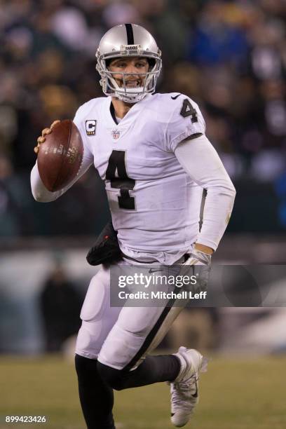 Derek Carr of the Oakland Raiders scrambles against the Philadelphia Eagles at Lincoln Financial Field on December 25, 2017 in Philadelphia,...