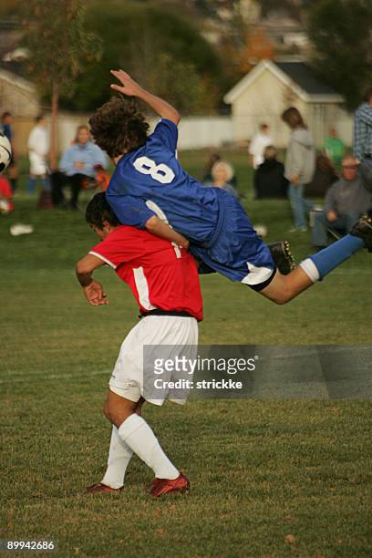 two male soccer players collide in midair vying for header - soccer injury stock pictures, royalty-free photos & images