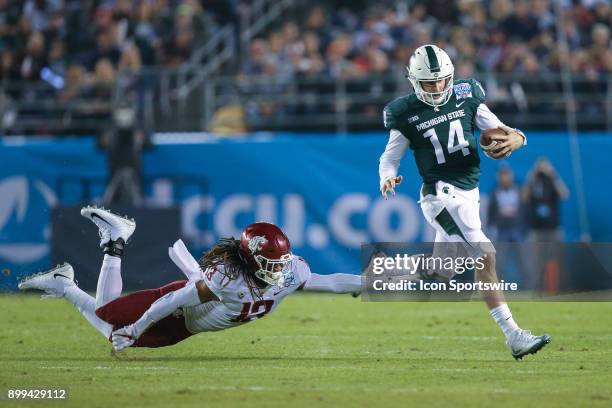 Brian Lewerke of the Michigan State Spartans runs for a gain in the game between the Washington State Cougars and the Michigan State Spartans in the...