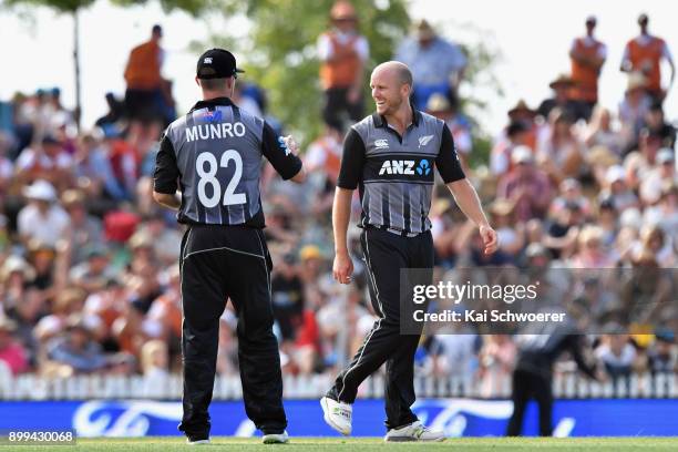 Seth Rance of New Zealand is congratulated by Colin Munro of New Zealand after taking the final wicket to give New Zealand victory over the West...