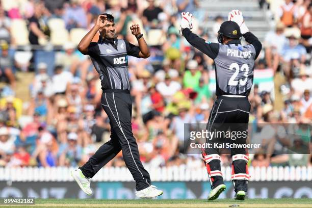 Ish Sodhi of New Zealand is congratulated by Glenn Phillips of New Zealand after dismissing Andre Fletcher of the West Indies during game one of the...