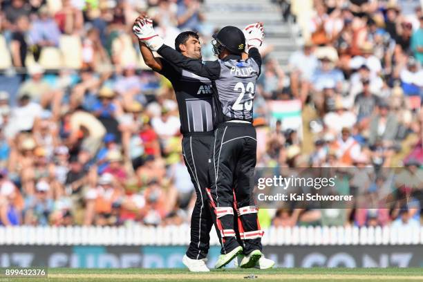 Ish Sodhi of New Zealand is congratulated by Glenn Phillips of New Zealand after dismissing Andre Fletcher of the West Indies during game one of the...