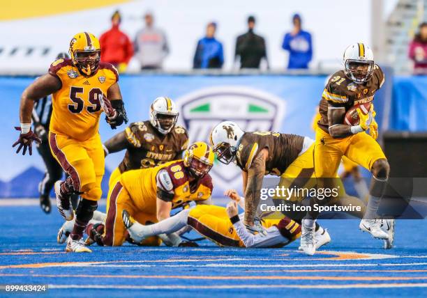 Wyoming Cowboys defensive end Carl Granderson turns up field with the ball after a fumbled by Central Michigan Chippewas quarterback Shane Morris...