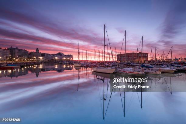 sunrise at " la darsena" with sun reflections and boats - darsena stock-fotos und bilder