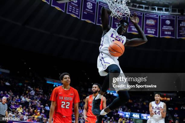 Tigers forward Mayan Kiir dunks the ball against Sam Houston State Bearkats guard Marcus Harris on December 19, 2017 at Pete Maravich Assembly Center...