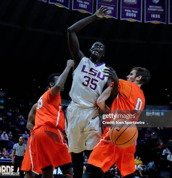 Tigers forward Mayan Kiir is fouled by Sam Houston State Bearkats guard Albert Almanza and forward Chidozie Ndu on December 19, 2017 at Pete Maravich...