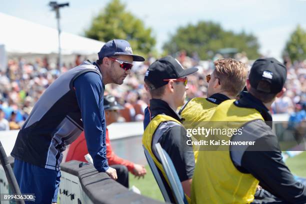 Head Coach Mike Hesson of New Zealand speaks to Lockie Ferguson of New Zealand during game one of the Twenty20 series between New Zealand and the...