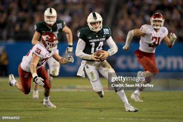 Brian Lewerke of the Michigan State Spartans eludes Dylan Hanser of the Washington State Cougars on a run play during the second half of the SDCCU...