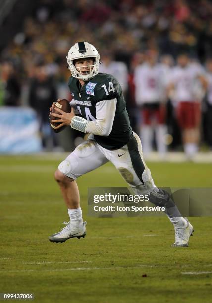 Michigan State Spartans quarterback Brian Lewerke on the run in the third quarter of the Holiday Bowl played against the Washington State Cougars, on...