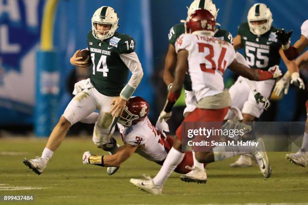 Brian Lewerke of the Michigan State Spartans eludes Isaac Dotson of the Washington State Cougars during the first half of the SDCCU Holiday Bowl at...