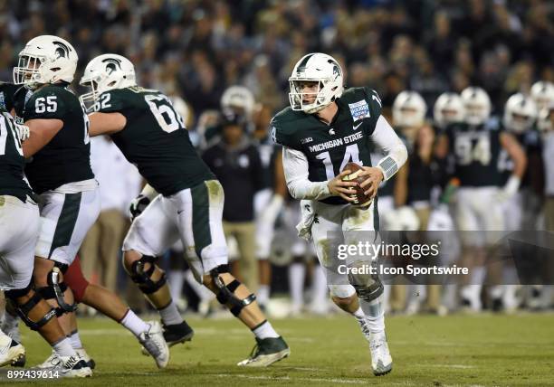 Michigan State Brian Lewerke runs the ball during the Holiday Bowl game between the Washington State Cougars and the Michigan State Spartans on...