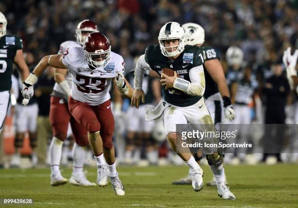 Michigan State Brian Lewerke runs the ball during the Holiday Bowl game between the Washington State Cougars and the Michigan State Spartans on...
