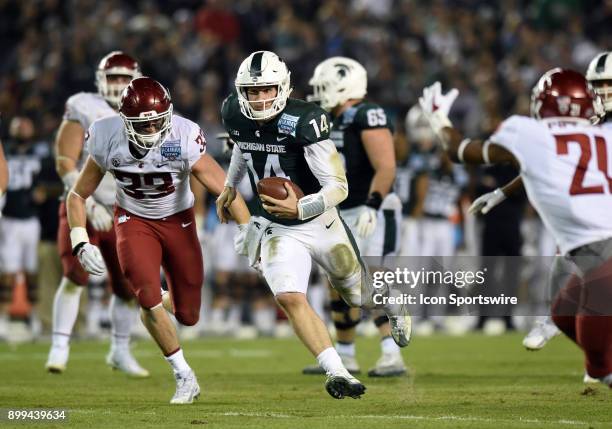 Michigan State Brian Lewerke runs the ball during the Holiday Bowl game between the Washington State Cougars and the Michigan State Spartans on...