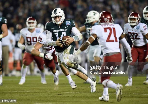 Michigan State Brian Lewerke runs the ball during the Holiday Bowl game between the Washington State Cougars and the Michigan State Spartans on...