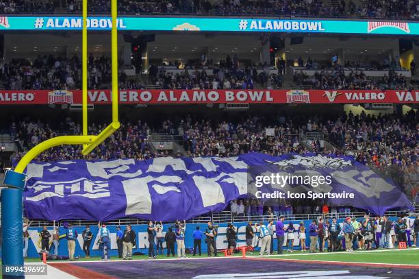 The TCU crowd unfurls a "Fear the Frog" banner in the lower section of the stadium late in the game during the Alamo Bowl game between the Stanford...