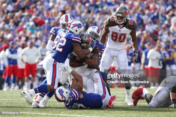 Tampa Bay Buccaneers running back Doug Martin is stopped by Buffalo Bills middle linebacker Preston Brown and Buffalo Bills outside linebacker...