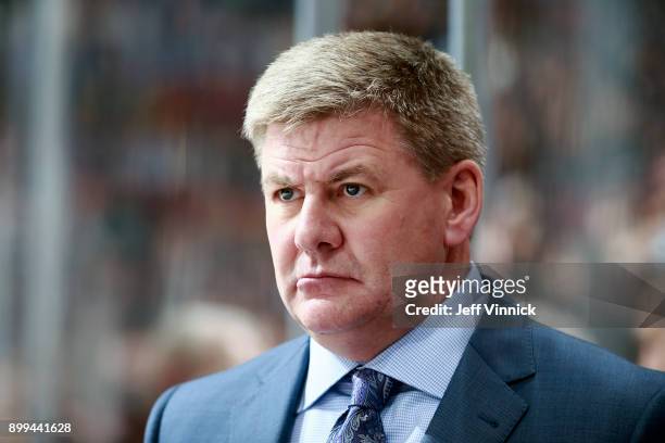 Head coach Bill Peters of the Carolina Hurricanes looks on from the bench during their NHL game against the Vancouver Canucks at Rogers Arena...