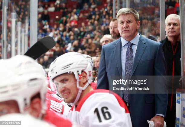 Head coach Bill Peters of the Carolina Hurricanes looks on from the bench during their NHL game against the Vancouver Canucks at Rogers Arena...