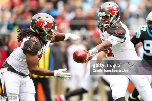 Tampa Bay Buccaneers quarterback Jameis Winston hands off to running back Doug Martin during the first half between the Tampa Bay Buccaneers and the...