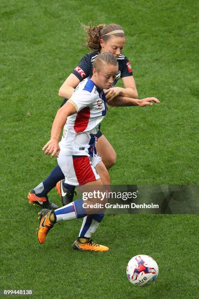 Jenna Kingsley of the Jets runs with the ball under pressure from the Victory defence during the round nine W-League match between the Melbourne...