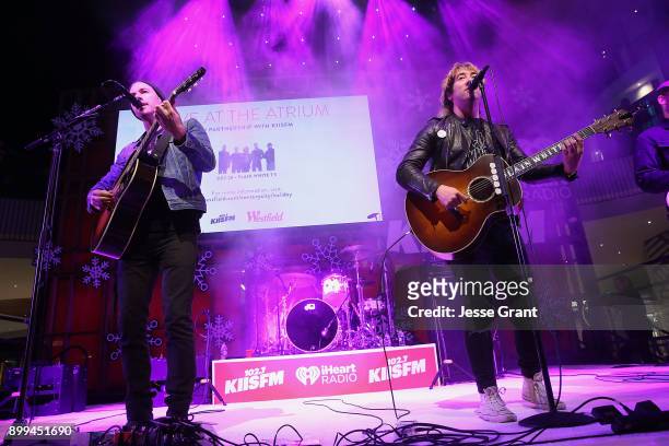 Musicians Tim Lopez and Tom Higgenson of Plain White T's perform onstage during the 'Live at the Atrium' Holiday Concert Series in Partnership with...