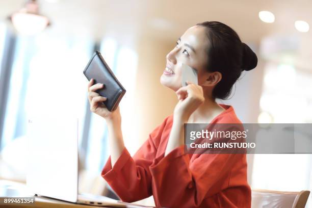 middle aged woman online shopping at cafe - lady wallet stock pictures, royalty-free photos & images