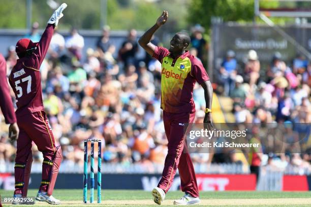 Carlos Brathwaite of the West Indies is congratulated by Chadwick Walton of the West Indies after dismissing Doug Bracewell of New Zealand during...