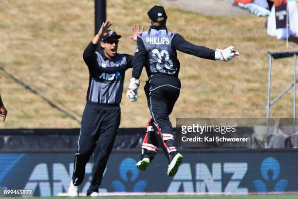 Glenn Phillips of New Zealand is congratulated by Ross Taylor of New Zealand after taking a catch to dismiss Chris Gayle of the West Indies during...