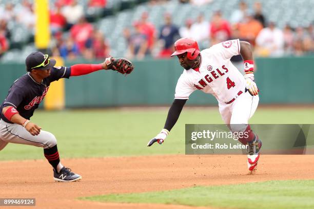 Brandon Phillips of the Los Angeles Angels of Anaheim tries to avoid the tag of Francisco Lindor during the game against the Cleveland Indians at...