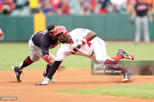 Brandon Phillips of the Los Angeles Angels of Anaheim tries to avoid the tag of Francisco Lindor during the game against the Cleveland Indians at...