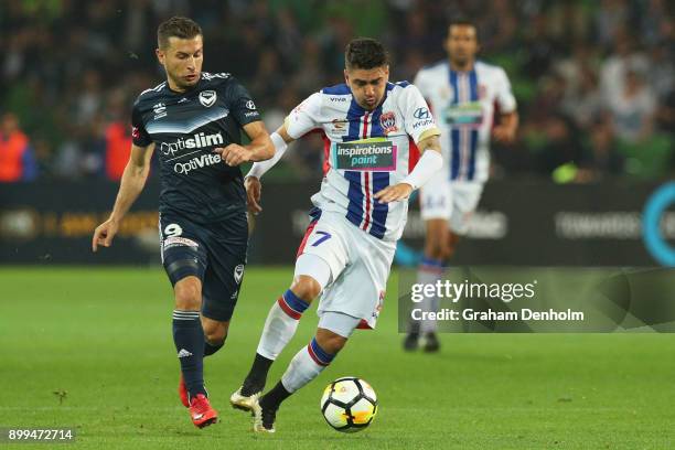 Kosta Barbarouses of the Victory and Dimitri Petratos of the Jets contest the ball during the round 13 A-League match between the Melbourne Victory...