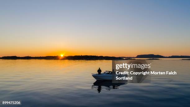 fishing in the evening - recreational boat stock pictures, royalty-free photos & images