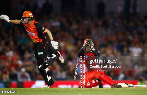 Wicketkeeper Tim Ludeman of the Renegades runs out Adam Voges of the Scorchers during the Big Bash League match between the Melbourne Renegades and...