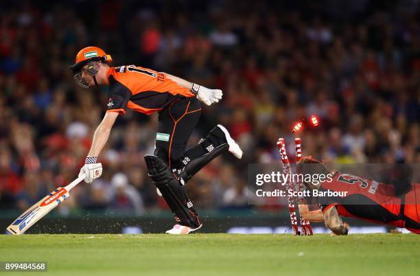 Kane Richardson of the Renegades attempts to run out Andrew Tye of the Scorchers during the Big Bash League match between the Melbourne Renegades and...