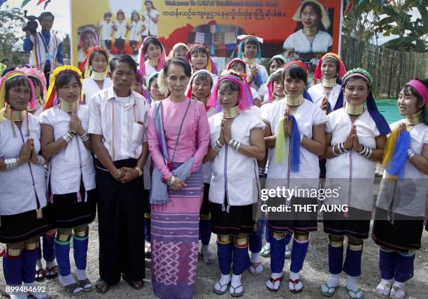 Myanmar's State Counselor Aung San Suu Kyi poses with locals at Daw Hsan Boon village in Loikaw on December 29, 2017.