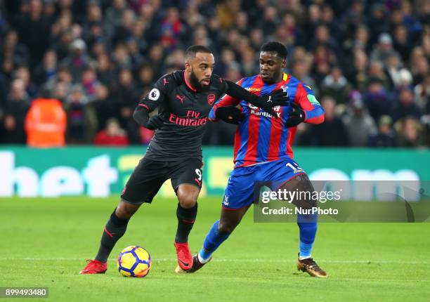 Arsenal's Alexandre Lacazette holds of Crystal Palace's Jeffrey Schlupp during Premier League match between Crystal Palace and Arsenal at Selhurst...