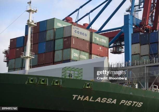 Shipping containers sit on the Thalassa Pistis container vessel docked at the Hamburger Hafen und Logistik AG Container Terminal Burchardkai in the...