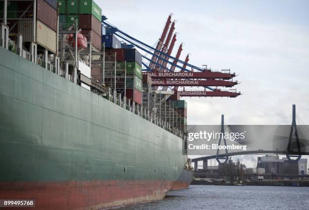 Shipping containers sit on the Thalassa Pistis container vessel docked at the Hamburger Hafen und Logistik AG Container Terminal Burchardkai in the...