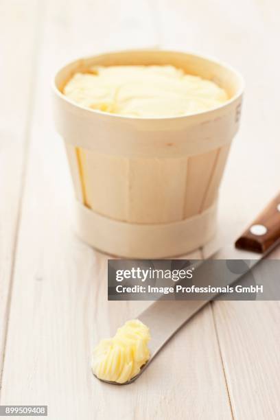 butter in a wood-chip basket and on a knife - butter churn fotografías e imágenes de stock