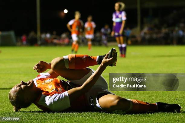 Tameka Butt of the Roar holds her foot after tackle by Natasha Rigby of the Perth Glory during the round nine W-League match between the Perth Glory...