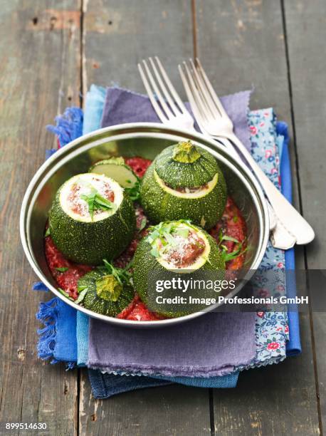 round courgettes with minced meat filling in tomato sauce - zucchine stock pictures, royalty-free photos & images