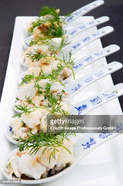 fried cod with apple cream on canap spoons - canap�� fotografías e imágenes de stock