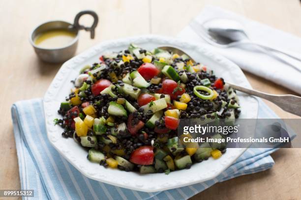 beluga lentil salad with courgette, peppers, cherry tomatoes and vinaigrette - zucchine stock pictures, royalty-free photos & images