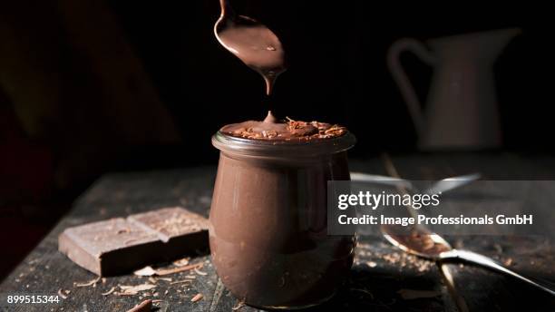 chocolate pudding with a spoon - blancmange stock pictures, royalty-free photos & images