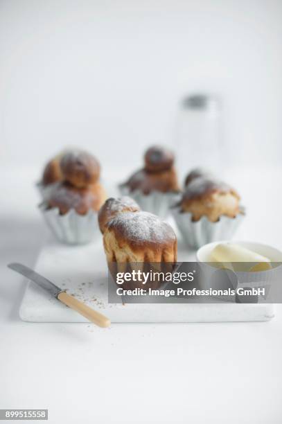 fresh brioches on a chopping board with butter and a knife - butter curl stock pictures, royalty-free photos & images