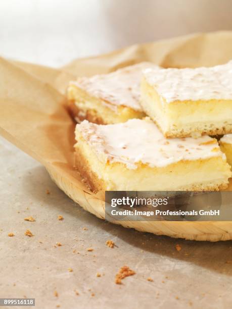 four slices of coconut and quark cake on a piece of baking paper - coconut chunks stock pictures, royalty-free photos & images
