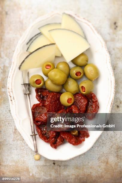 spanish cheese with olives and dried tomatoes - amuse bouche stockfoto's en -beelden